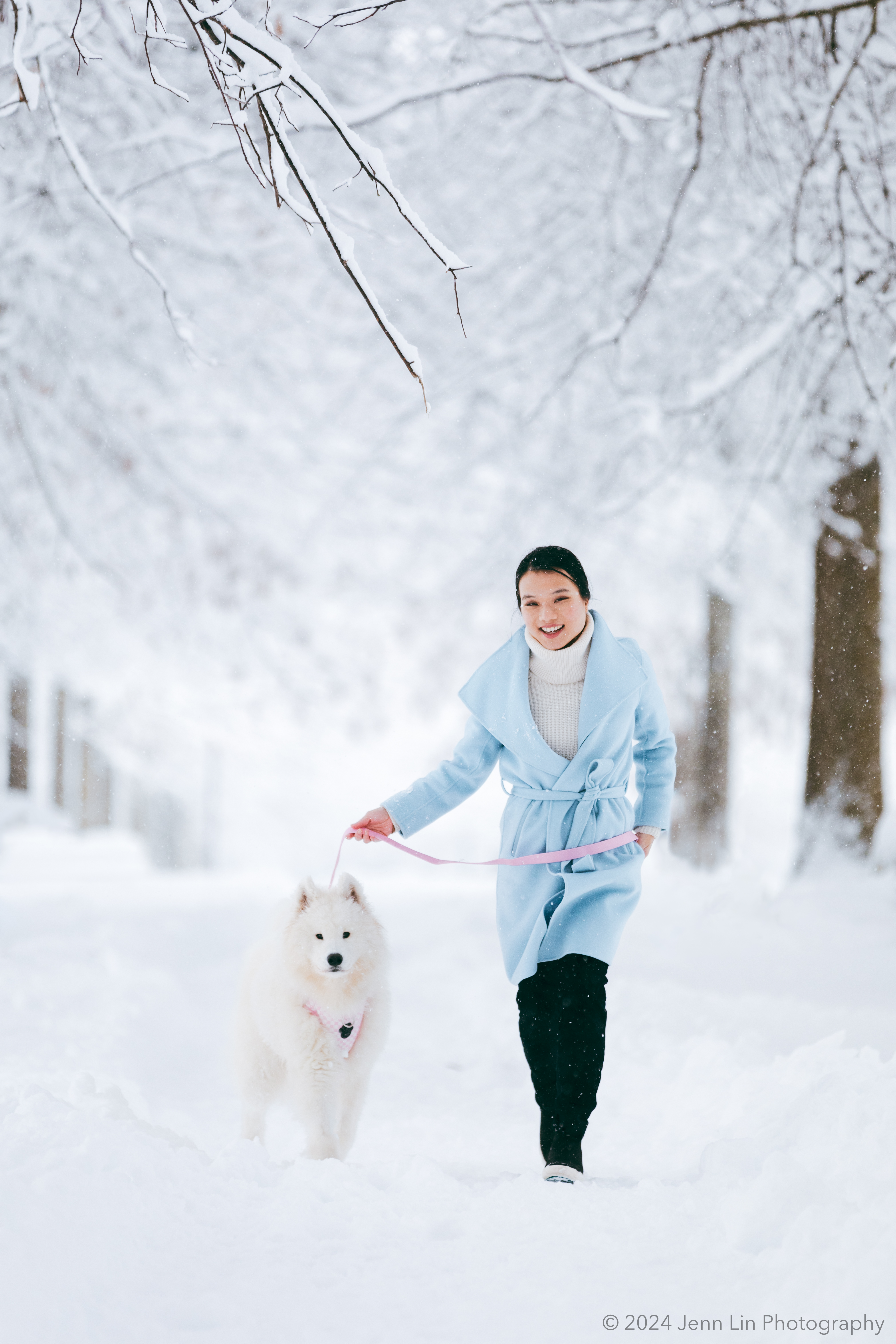 Lily walks through the fresh snow with her Samoyed puppy, Bao Bao, at King George Park in Richmond, BC. Photo captured for the story project, Dogs Will Teach You Love, Jan. 17, 2024 © Jenn Lin, All Rights Reserved.